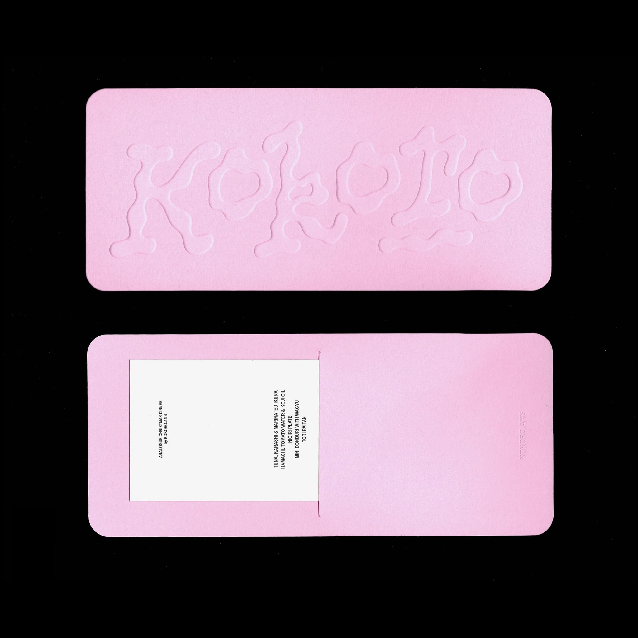 Kokoro's Amsterdam is a French-Japanese popup restaurant featuring a pink sleeve menu with an embossed logo.