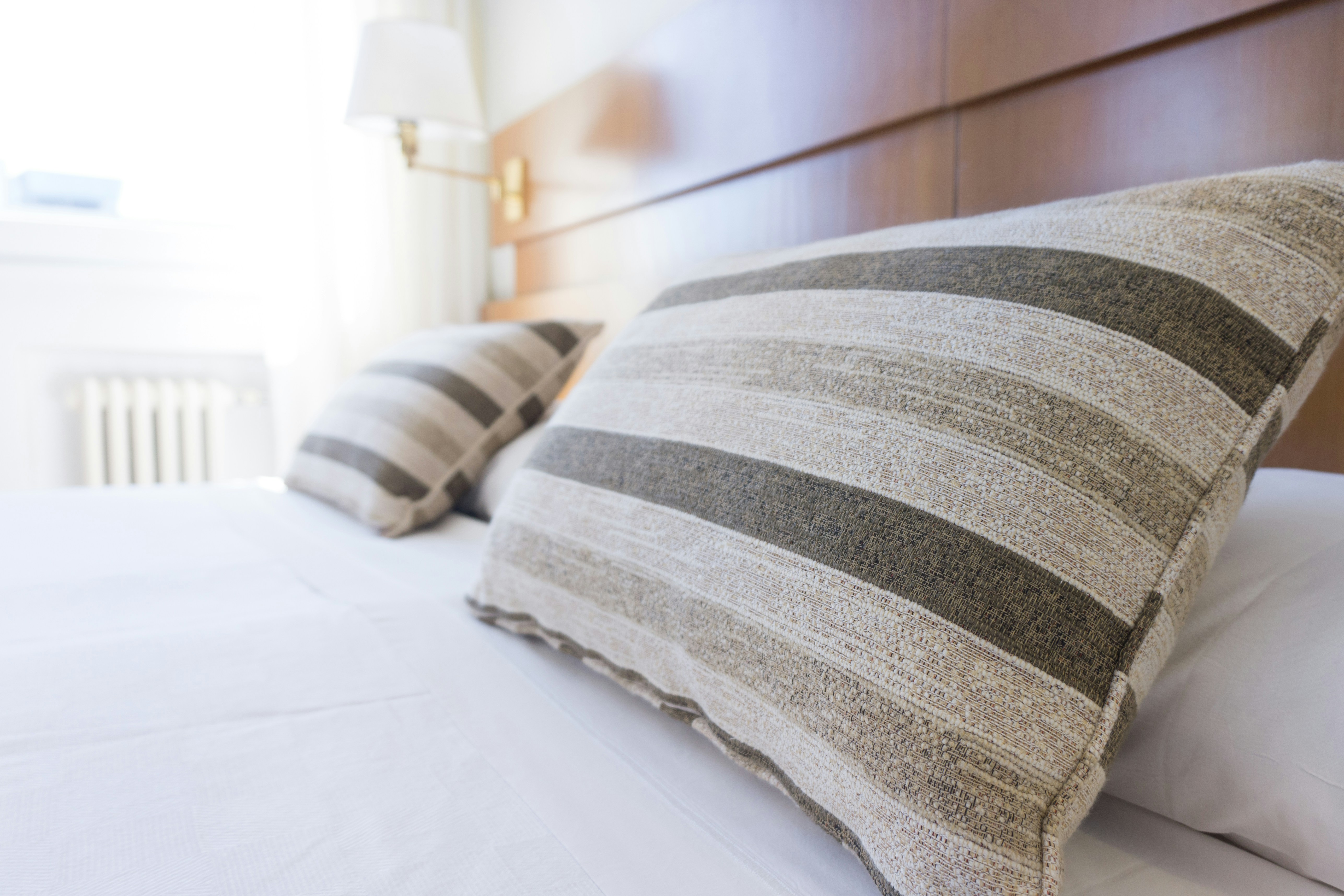 Une image en gros plan de coussins sur un lit d'hôtel